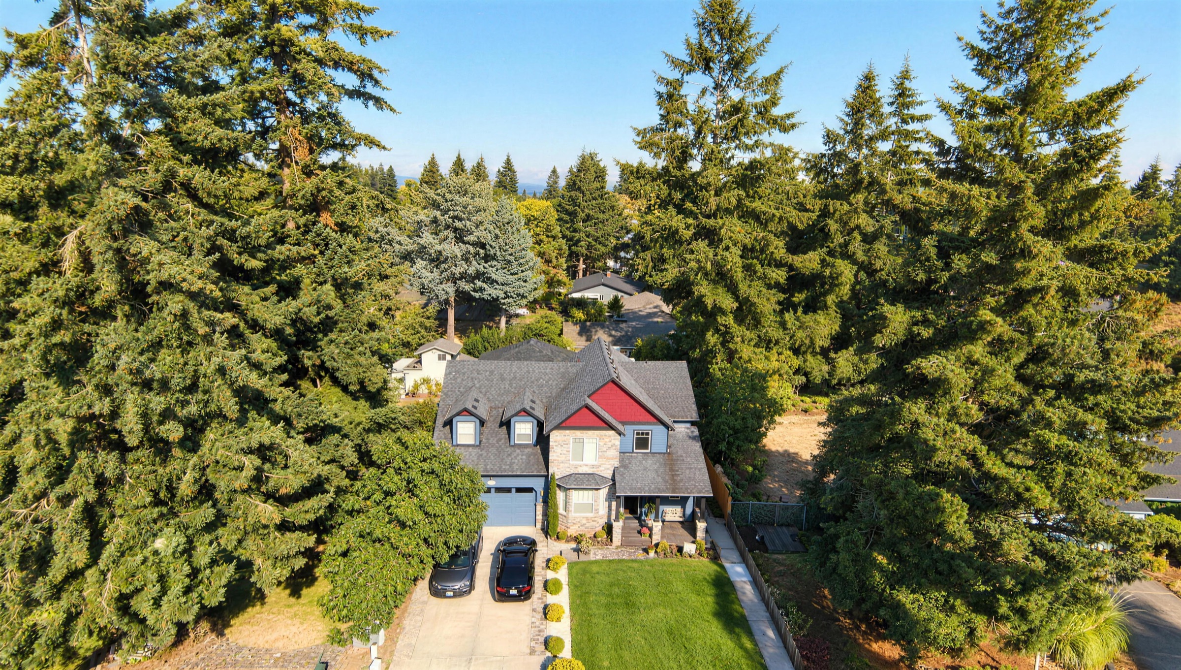 An aerial view of Rose Manor, nestled among tall fir trees on NE 139th Ave.